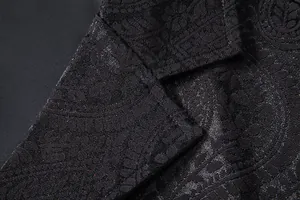 Close-up detail of premium black jacquard fabric and lapel stitching on a men's suit vest