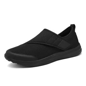 Lightweight black mesh walking shoes for seniors with adjustable velcro strap.