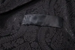 Detail showing black paisley jacquard fabric and satin pocket welt of men's suit vest