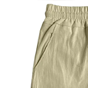 Macro detail view of elastic waistband and side pocket on khaki linen blend casual shorts