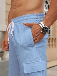 Close-up detail of light blue breathable cotton cargo shorts with side pocket and drawstring