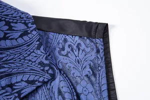 Macro detail of blue floral jacquard fabric and black satin collar trim on men's waistcoat.