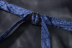 Close-up of adjustable metal buckle and paisley strap on men's suit waistcoat detail