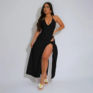 Model wearing a sexy black halter neck top and matching high slit wrap maxi skirt set
