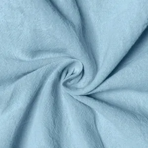 Macro close-up view of light blue breathable linen fabric texture for summer cargo shorts