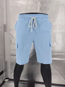 Detail showing the light blue linen texture and drawstring of these men's cargo shorts