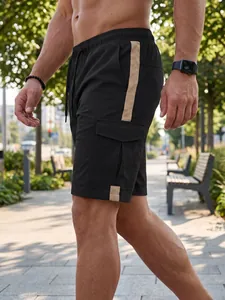 Macro view of men's black cargo shorts featuring a side cargo pocket and beige contrast stripe