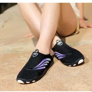 Détail de chaussures aquatiques noires respirantes avec motif d'aile violette pour plage.