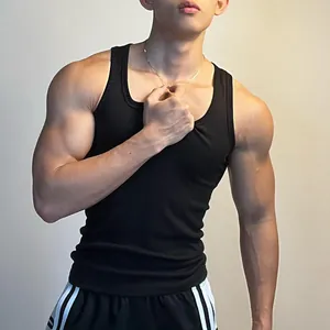 Detailed view of a black ribbed quick-dry fitness tank top for men shown on a model