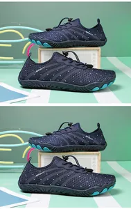 Navy blue breathable mesh water shoes with adjustable drawstring laces on a green background