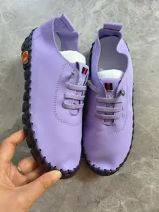 Detail view of purple hand-stitched casual women's shoes with comfortable soft sole