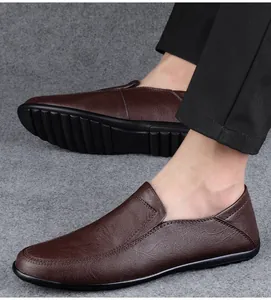 Detail view of men's dark brown soft leather slip-on loafers with flat black soles