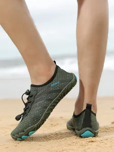 Breathable quick-dry outdoor water shoes for men and women on sandy beach.