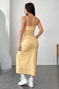Detailed back view of yellow daisy floral cami midi dress featuring adjustable straps