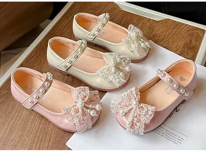 Elegant girls' princess shoes with lace bows and pearls in pink and cream colors
