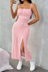 Detail view of a pink daisy print midi dress featuring a side slit and adjustable straps