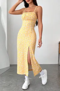 Full view detail of a yellow daisy print camisole midi dress with a high side slit