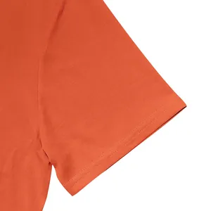 Close-up of double-stitched sleeve hem on men's quick-dry burnt orange polo shirt