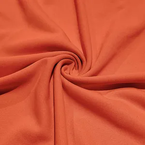 Detailed macro view of orange breathable quick-dry fabric texture for men's Polo shirt