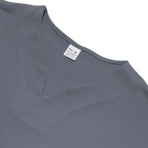 Close-up detail showing the collar and size tag of a grey V-neck jersey shirt for men