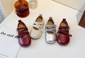 Collection of girls' Mary Jane flats in burgundy, beige, and metallic silver finishes.