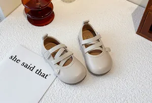 Elegant beige girls' Mary Jane shoes with cross straps and soft sole design