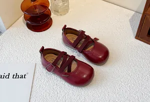 Close-up detail of stylish burgundy Mary Jane leather shoes for girls with soft soles