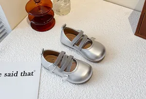 Detailed view of silver metallic girls' Mary Jane princess shoes with elastic straps