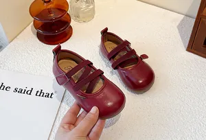 Detail of burgundy children's Mary Jane shoes with elastic straps and soft soles