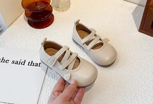 Close-up detail of cream beige children's Mary Jane shoes with soft leather finish