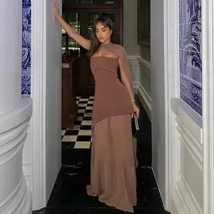 Model wearing a brown mesh tube dress with matching scarf in an elegant hallway