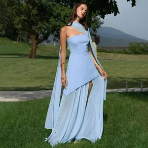 Detail showing the full silhouette of the light blue evening dress in a natural outdoor setting