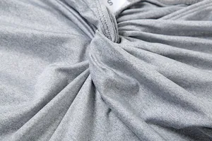 Macro view of the high-quality twisted knot detail on gray heathered bodysuit garment