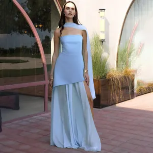 Close-up of sky blue strapless dress featuring mesh layering and elegant matching neck scarf