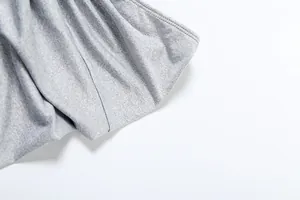 Close-up macro shot of the gray breathable fabric texture of the women's clothing set.