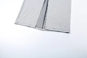 Detailed close-up showing the high slit hem of a grey slim fit knitted maxi skirt.