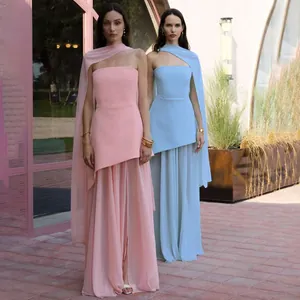 Elegant pink and light blue strapless maxi dresses with matching scarves in outdoor setting.