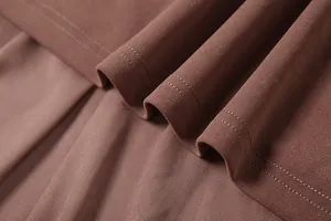 Close-up detail of brown mesh patchwork and professional stitching on a spring dress