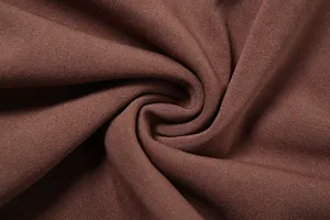 Detailed macro view showing the soft brown fabric texture of a women's slim-fit dress