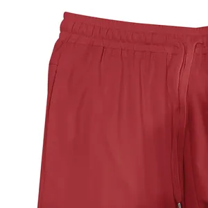 Detail view of red men's athletic shorts showing elastic waistband and adjustable drawstring