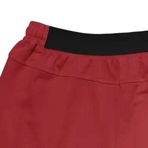 Close-up detail of breathable red men's athletic shorts with black elastic waistband