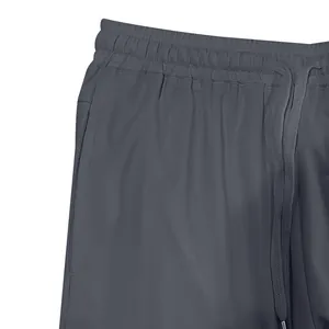 Detail of men's casual shorts featuring elastic waistband and braided drawstring.