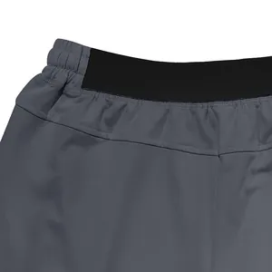 Close-up detail of the elastic waistband and stitching on grey men's casual jogging shorts