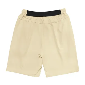 Back view of men's tan loose fit casual shorts with black elastic waistband