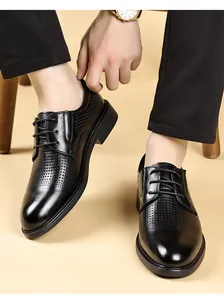 Detail view of black breathable hollow-out leather business casual dress shoes for men.