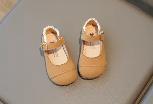 Nahaufnahme der braunen Wildlederschuhe für Mädchen mit Spitzenbesatz und weicher Sohle.