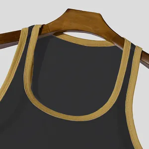 Detail view of men's black mesh fitness tank top featuring tan trim on a wooden hanger