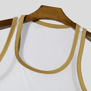Close-up of white mesh sports tank top with mustard yellow neckline detail