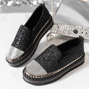 Dettaglio di mocassini neri platform con punte ricoperte di strass argentati lucidi
