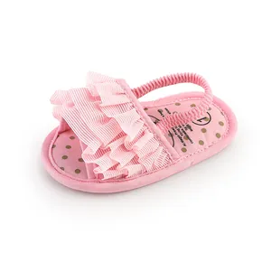 Detailed view of pink ruffle baby sandals with elastic back strap